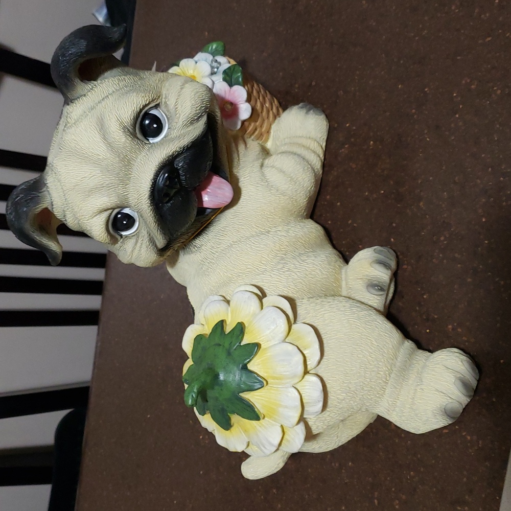 Solar-powered pug dog figurine designed for outdoor decoration.